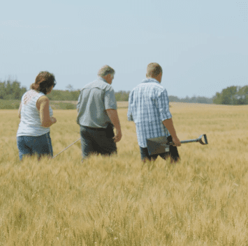 Our History Three People Walking Through Field